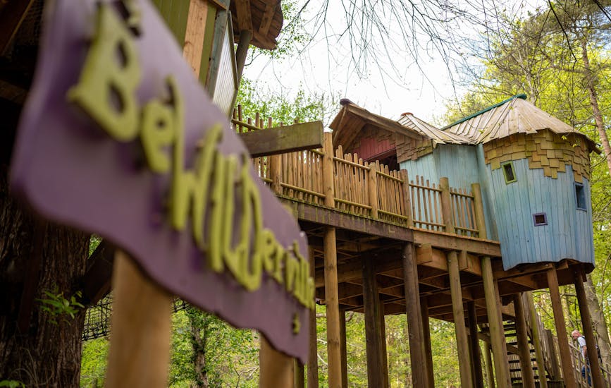 A large blue and pink wooden treehouse in BeWILDerwood Norfolk