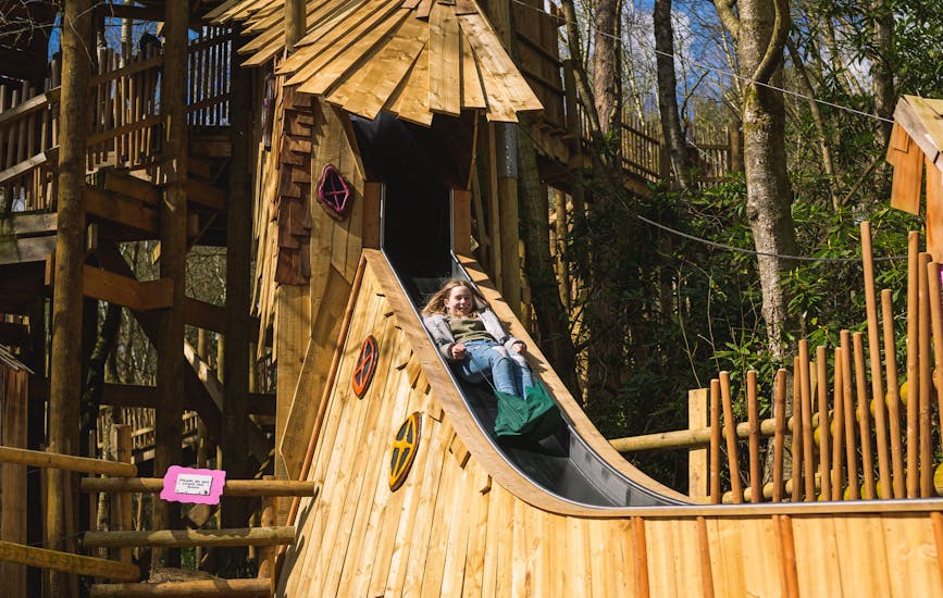 A child plays on the slide on the Broken Bridge in BeWILDerwood Cheshire