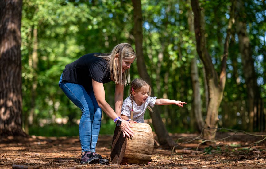 A mother and child build a den at BeWILDerwood