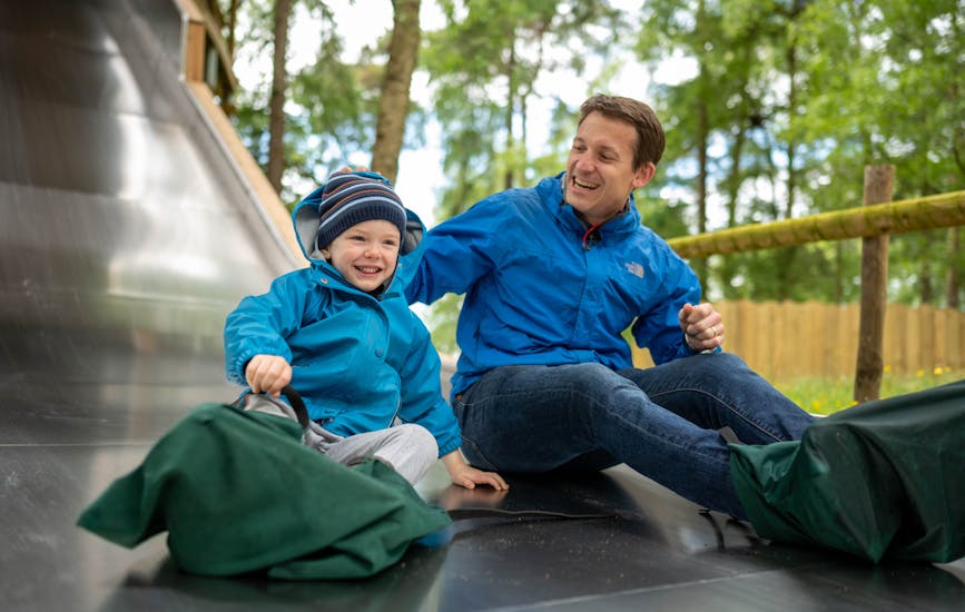 A father and son enjoy the slides at BeWILDerwood