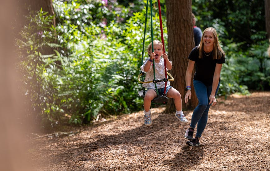 A mother and daughter play on the Twiggle Whizzers at BeWILDerwood