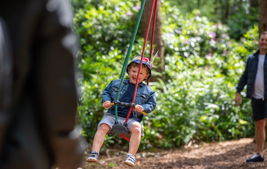 A little boy plays on the Twiggle Whizzers at BeWILDerwood