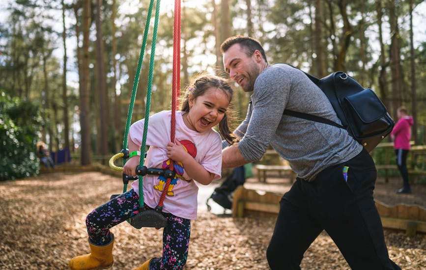 A father and daughter play on the Twiggle Whizzers at BeWILDerwood