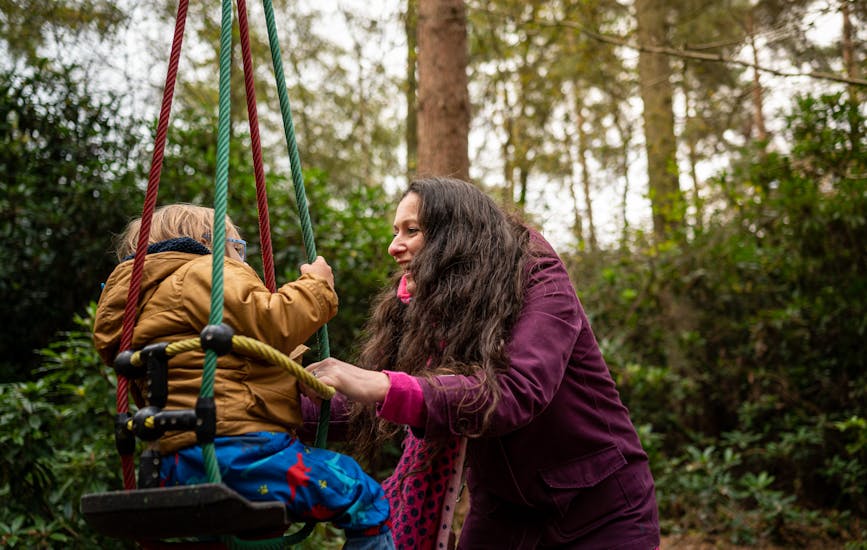 A mother and child play on the Twiggle Whizzers at BeWILDerwood