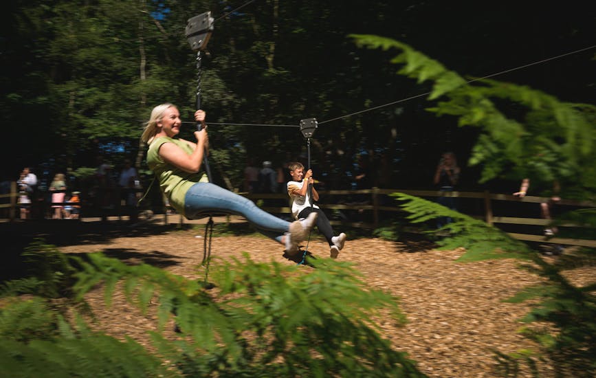 Mum and son playing on the zip lines at BeWILDerwood Norfolk