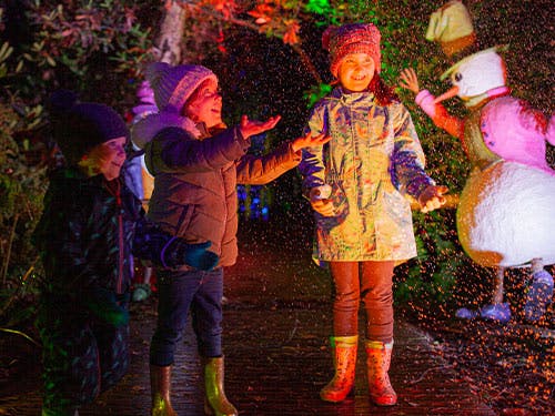 Children play in the snow during BeWILDerwood Presents Christmas