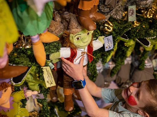 A boy holds a Swampy puppet
