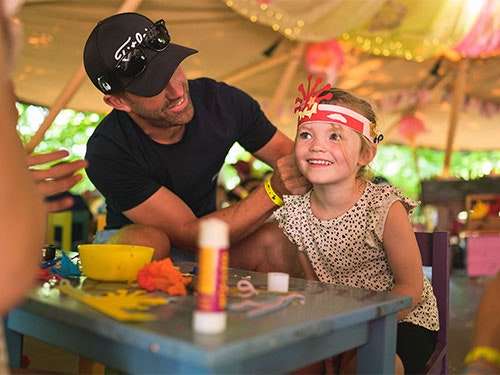 A father and daughter craft a crown together at BeWILDerwood